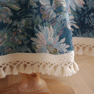 Blue vintage jacquard floral tablecloth with woven fringe tassels and detailed texture