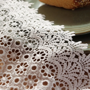 White floral hollow lace table runner with intricate embroidery for elegant wedding decor