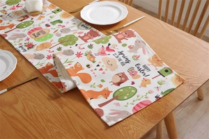 Detailed view of Easter table runner featuring printed rabbits and floral patterns on wood