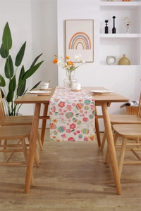 Close-up of Easter table runner with colorful eggs and floral print on linen texture
