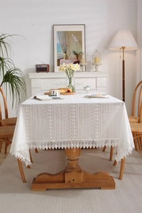 Macro detail of white hollow lace tablecloth with vintage crochet floral embroidery patterns