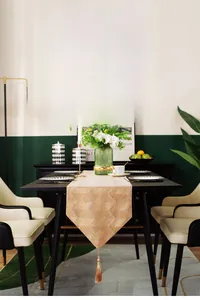 Detail of luxury champagne gold table runner with chevron jacquard pattern and tassel