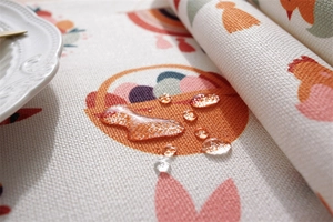 Detail of waterproof Easter table runner fabric with Easter eggs and water droplets