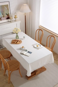 Close-up of elegant white cotton lace tablecloth with intricate hollow embroidery detailing
