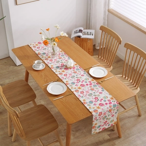 Modern Easter table runner with colorful eggs and floral print on white thick cotton