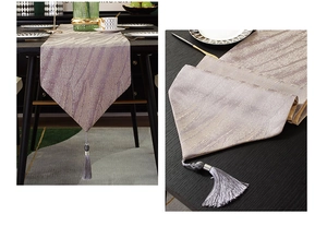 Detail of luxury lilac jacquard table runner with abstract texture and silver tassels