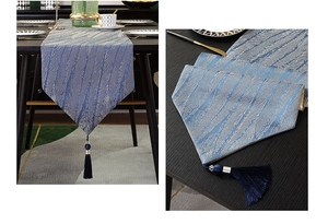 Blue jacquard table runner with silver feather pattern and deep blue hanging tassels
