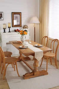 Close-up of beige crochet lace table runner with hollow patterns and elegant tassels