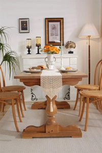 Detail of vintage crochet table runner featuring geometric lace patterns and fringe tassels