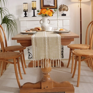 Boho style beige table runner with white geometric jacquard and fringe tassels