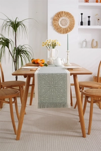 Detailed close-up of retro geometric jacquard table runner with beige tassel edges