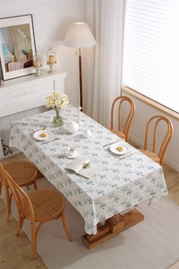 Detail of floral cotton tablecloth featuring green leaves and pink flowers print