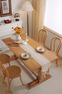 Close-up of vintage crochet lace table runner with hollow patterns and fringe tassels