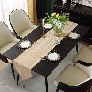 Modern champagne gold jacquard table runner with herringbone pattern and elegant tassels