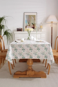 Detail of French cotton tablecloth with green leaf print and delicate fringe edges