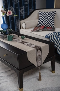 Detail of New Chinese style table runner with traditional longevity pattern and tassel