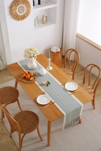 Close-up of bohemian jacquard table runner with geometric patterns and tassels