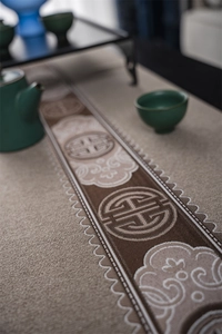Detail of Chinese style table runner with Shou character jacquard and fringe edges
