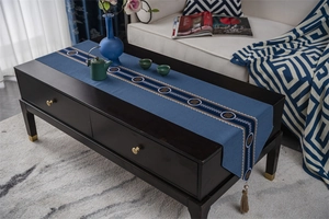 Detailed view of dark blue Chinese style table runner with elegant tassels and jacquard pattern