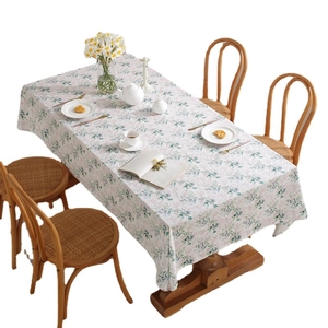 French cotton floral tablecloth with green leaves and pink flowers on wood table