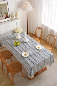 Close-up detail of blue and white geometric patterns on a bohemian tablecloth with tassels