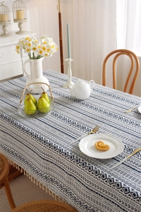 Close-up of bohemian blue geometric tablecloth with cream tassel fringe decor