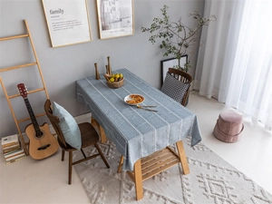 Modern grey-blue rectangular tablecloth with white vertical stripes in a home dining scene