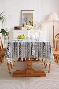 Close-up of bohemian navy and white geometric pattern tablecloth with tassel edges