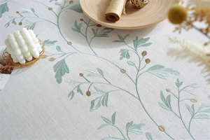 Detail of premium cotton linen tablecloth featuring exquisite floral leaf embroidery
