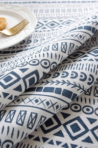 Close-up of bohemian geometric table cloth with navy blue patterns and thick texture