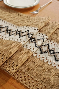 Close-up of bohemian linen table runner with geometric patterns and fringe edges