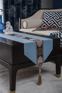 Close-up of sky blue table runner with traditional cloud patterns and elegant tassels