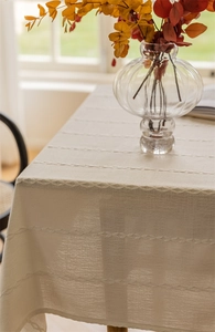 Detailed macro view of white geometric textured polyester jacquard tablecloth fabric