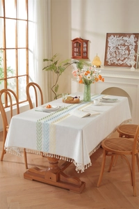 Detail of embroidered floral pattern and fringe tassels on waterproof rectangle tablecloth