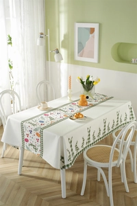 Detailed close-up of Easter polyester tablecloth with sage green plaid rabbits and eggs