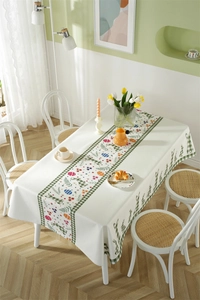 Detail of Easter tablecloth with green plaid, colorful eggs, and bunny pattern