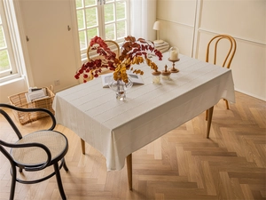 Detail showing wavy textured white polyester jacquard fabric on a rectangular tablecloth