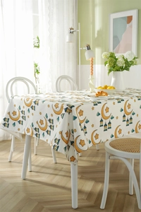 Detailed view of polyester tablecloth featuring moon and star patterns for dining tables