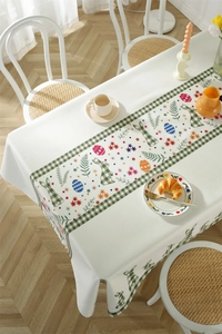 Detail of waterproof Easter tablecloth featuring rabbit and green plaid floral patterns
