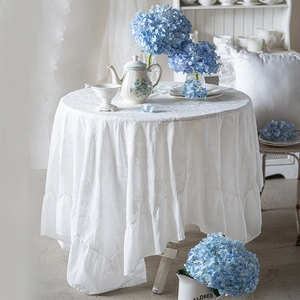 White French cotton round tablecloth with elegant floral embroidery and ruffled edge decor