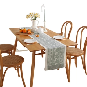 Green Nordic table runner with reindeer and snowflake patterns and decorative tassels