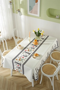 Close-up of Easter tablecloth featuring plaid rabbits, flowers, and dot patterns