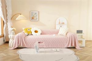 Detailed knit texture of pink jacquard sofa cover with 3D diamond pattern and fringe edge