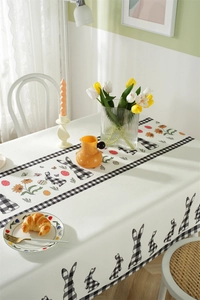 Detail of waterproof Easter tablecloth featuring rabbit patterns and plaid border decor