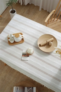 Detail of Nordic striped tablecloth featuring woven texture and white fringe tassels