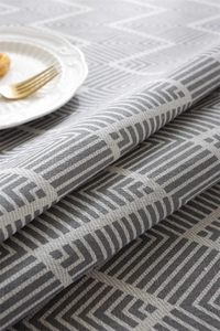 Close-up of woven polyester-cotton tablecloth with grey bohemian geometric pattern