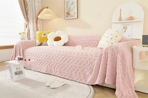 Close-up of thick pink jacquard sofa cover showing rich textured diamond knit patterns