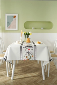 Close-up of waterproof Easter tablecloth featuring plaid bunnies and floral prints