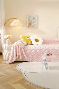 Close-up of pink thickened plush sofa cover with elegant jacquard diamond texture