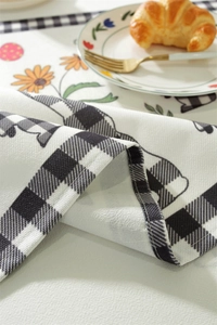 Detail of waterproof Easter tablecloth featuring plaid patterns and floral rabbit prints
